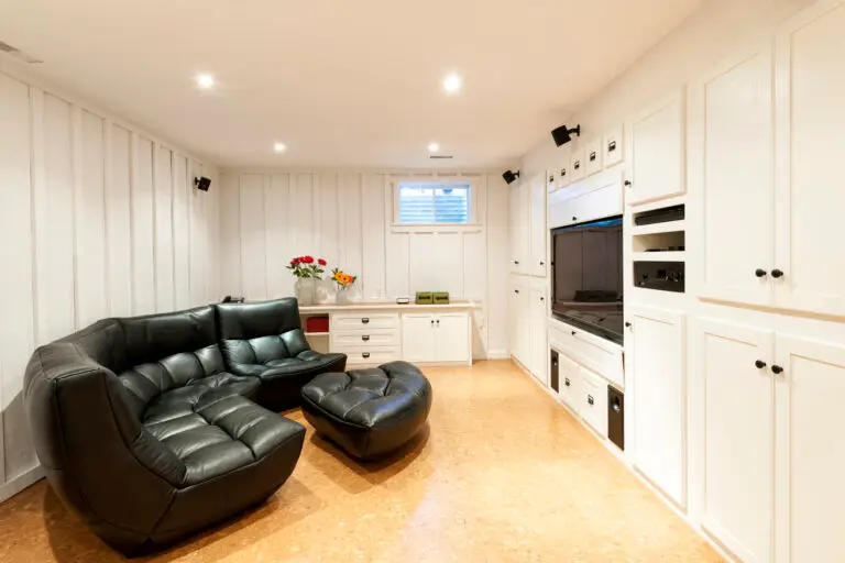 Off-white room with built-in cabinetry, TV, AV equipment, and speakers