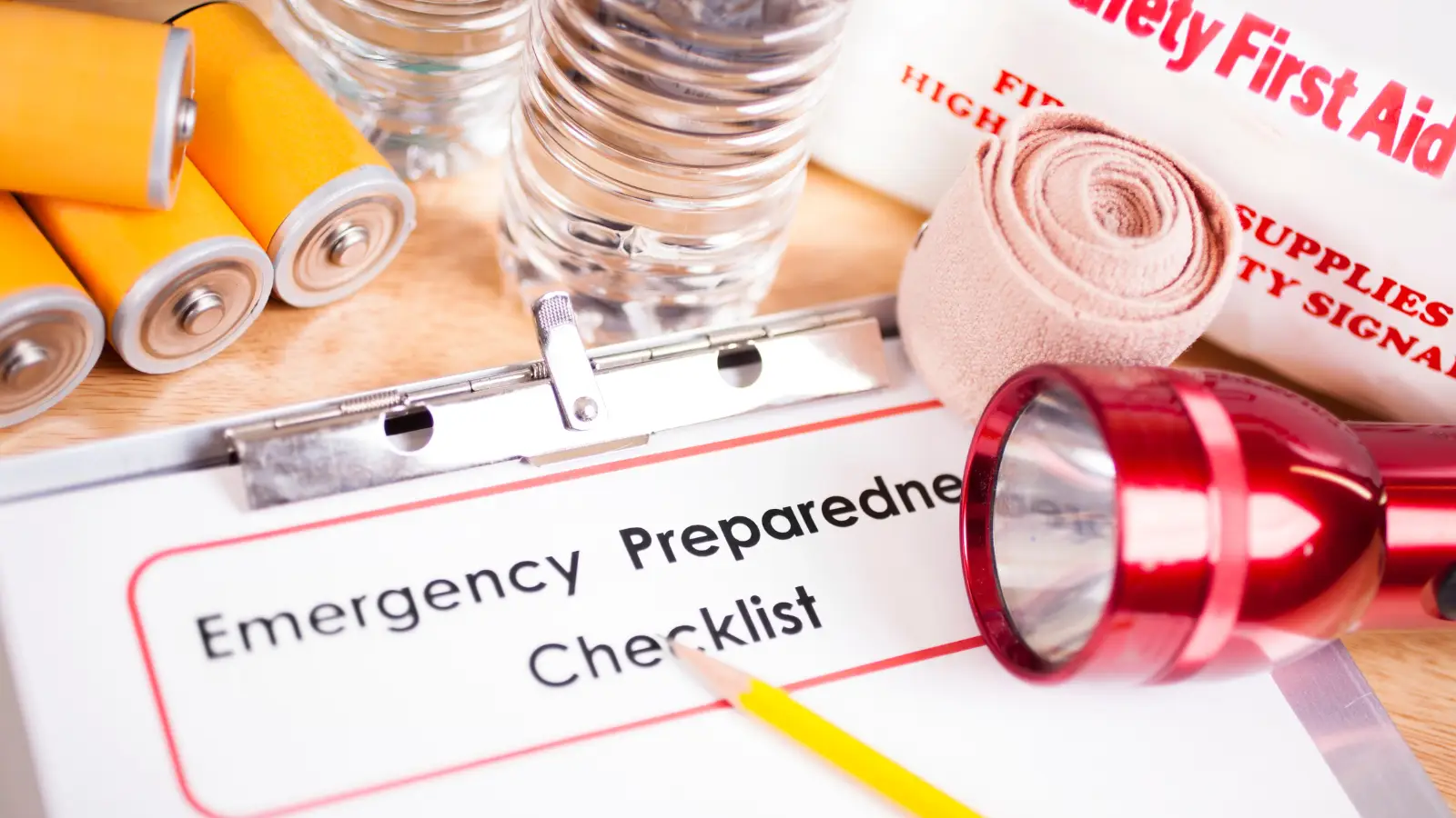 Emergency preparedness checklist with a flashlight, bandage, and bottle of water