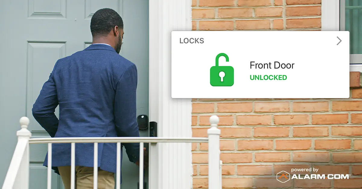 Man entering front door with security app showing "Front Door: Unlocked"