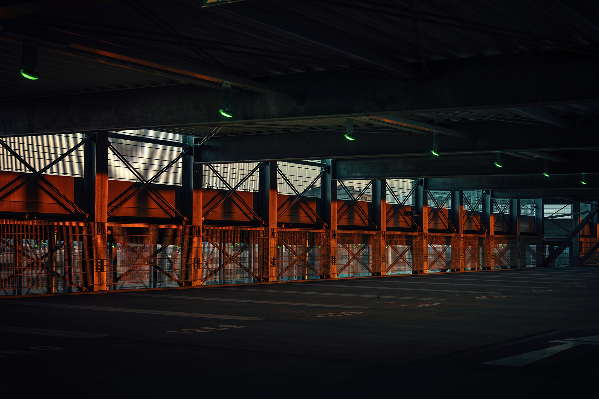 Commercial parking area with security lighting and industrial structure, illustrating secure facility design.